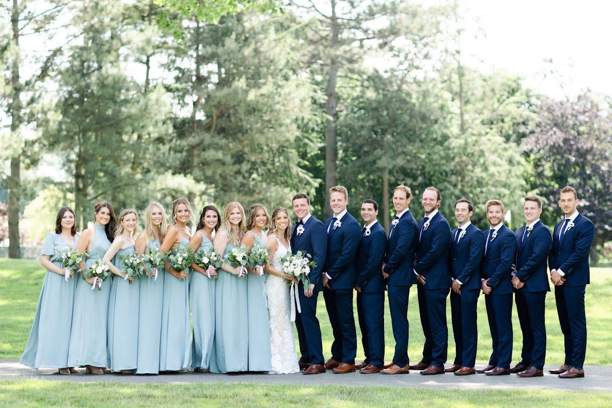 Tips on selecting the right blue suit color for your wedding party based on your bridesmaid dress