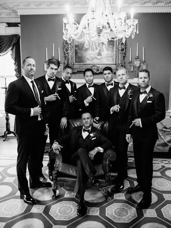 Groom and groomsmen in black tuxedos with shawl lapel